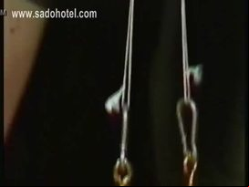 Naked slave with nice tits is spanked and hits herself on her pussy in a dungeon